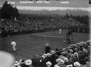 Black and White Photograph of a lawn tennis match.